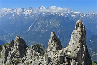 View over rocky outcrops on the slopes of the Pierre Avoi summit to the mountain range of the Savoy