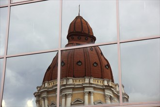 City of Targu Mures, Buna Vestire church, church tower reflected in a glass façade, Romania, Europe