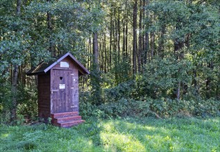 Wooden toilet block in a car park for hikers in the south of the Wigry National Park near Krusznik