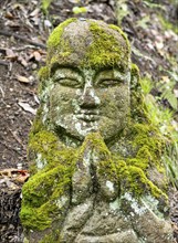 Close-up of moss-covered stone statue of rakan, the disciple of Buddha, Otagi Nenbutsu-ji temple,