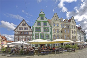 Historic restaurant Hofbräu am Dom with green tail gable and houses, green, street pub, people,