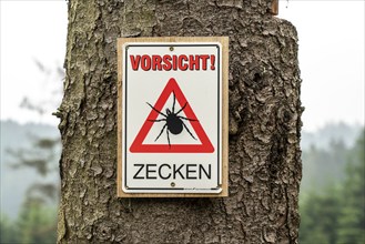 Warning sign for ticks, in the Arnsberg Forest, near Hirschberg, Sauerland, North Rhine-Westphalia,