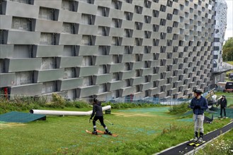 CopenHill, waste incineration plant and artificial ski slope, skiing with a view of the ski lift,