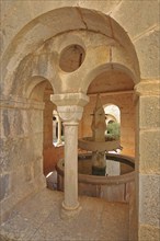 View through the window of the well house of the Romanesque abbey Le Thoronet, well, column,