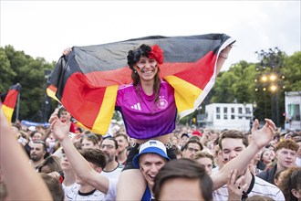 Celinda celebrates with a German flag on her boyfriend's shoulders in the fan zone at the