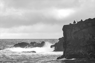 Anglers and rocks, surf on Lanzarote, Spain, Europe