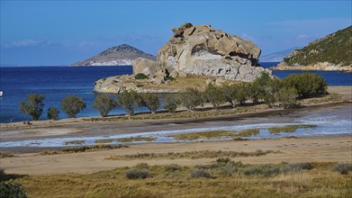 Tranquil coastline with a rocky island, trees and blue water, a sign of unspoilt nature, Petras