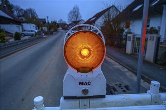 Warning light at a construction site in front of a village street, Eckental, Middle Franconia,