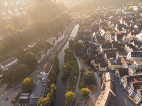 Wide-angle aerial view of a town at sunset with a river and multi-storey buildings, Calw, Black