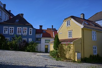 Colourful houses on a sunny day with cobblestone street and blue sky, Bergen, Vestland, Norway,