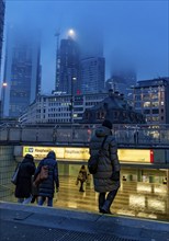 Rainy weather, freezing rain, entrance to Hauptwache underground station, high-rise skyline in