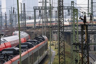 Railway tracks with regional and long-distance trains, ICE, after freezing rain, in front of