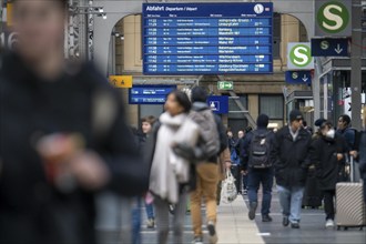 Station concourse, display board, timetable, travellers in the main station of Frankfurt am Main,