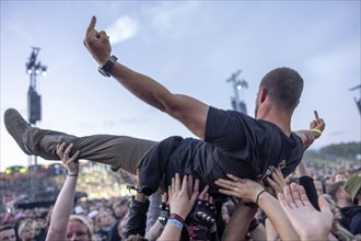 Copenhagen, Denmark - 19.6.2024: Festivalgoers crowdsurfing at the Copenhell Metal Festival at