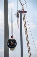 Erection of an Enercon E-160 wind turbine, rear, assembly of the first blade, 4 turbines with a