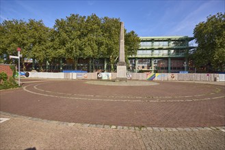 Roundabout with memorial to the fall of the Berlin Wall and the renovation of the town hall in