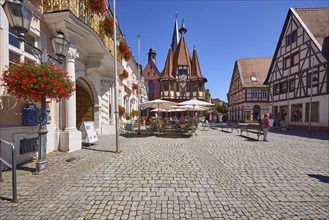 Market square with lantern, outdoor area of a café and historic town hall in Michelstadt, Odenwald,