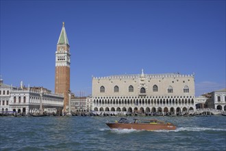 Taxi boat behind St Mark's Square tower and Palazzo Ducale, Venice, Metropolitan City of Venice,