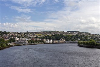 River with neighbouring city under blue sky and clouds, Londonderry