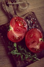 Sliced tomato, on a wooden chopping board, food background, no people