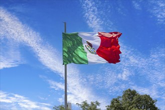 Los Cabos, Mexico, Mexican tricolor national striped flag proudly waving at mast in the air with