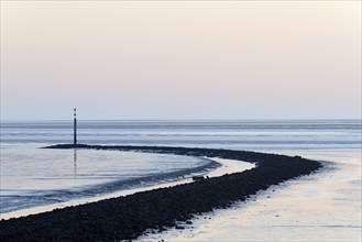 Evening mood at the Wadden Sea, stone groyne with sea mark, North Sea, Norddeich, Lower Saxony,