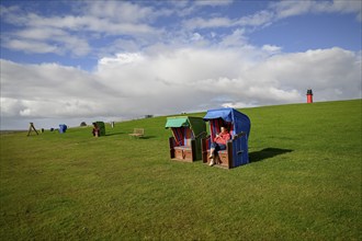 Woman in a beach chair on the island of Pellworm, Wadden Sea National Park, North Frisia, Germany,