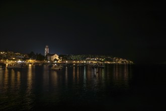 Night view of a town on the waterfront with illuminated buildings and boats, Hvar, Croatia, Europe