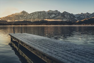 Frosty morning atmosphere during sunrise at Lake Hopfensee in the Allgäu in Bavaria, Germany,