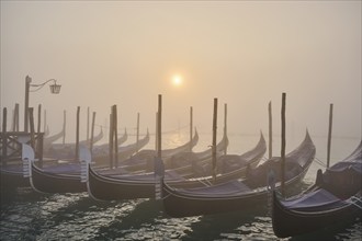 View from 'Colonna di San Marco e San Teodoro' on the gondolas lying in the water at sunrise in