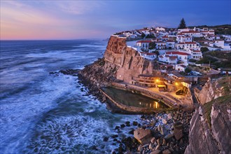 Scenic view of the seaside Azenhas do Mar fishing village on cliff on Atlantic ocean coast,