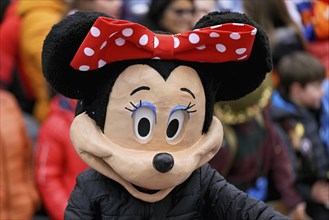 Person masked as Mickey Mouse at the carnival parade of the Wey guild on Rose Monday, Güdismäntig,