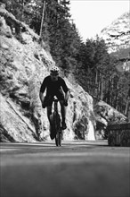 Road bike rider in spring between Lechtal and Tannheimer Tal in front of picturesque scenery of the