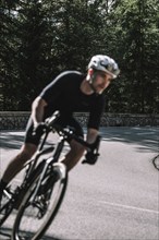 Road bike rider in spring between Lechtal and Tannheimer Tal in front of picturesque scenery of the