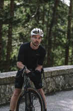 Road bike rider in spring in the Allgäu against the picturesque backdrop of the Alps, Bavaria,