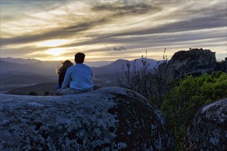 Couple enjoying the view of Meteora, sunset, Thessaly, Greece, Europe