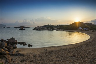 Lonely beach with granite rocks and campers, wild campsite, sunrise, Spiaggia Poltu Manzu, Capo