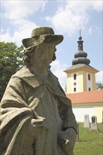 Weathered figure of an apostle in the historic cemetery of the pilgrimage church of Maria Loreto in