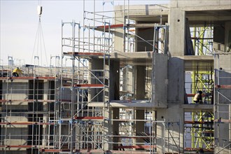 Photo of a large construction site in a newly developed residential area. Several apartment