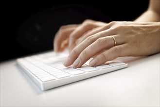 Hands typing on a keyboard in Berlin, 09/08/2024