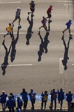 Marathon runners and their shadows at the 50th BMW Berlin Marathon 2024 on 29 September 2024