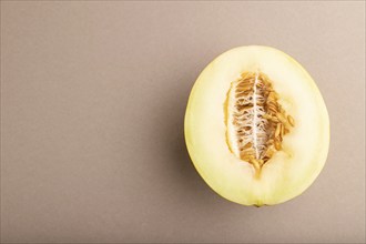 Sliced ripe yellow melon on brown pastel background. Top view, flat lay, copy space. harvest, women