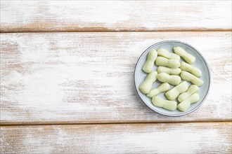 Jelly celery candies on white wooden background. copy space, top view, flat lay