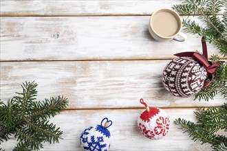 Christmas or New Year composition. Decorations, knitted balls, fir and spruce branches, cup of