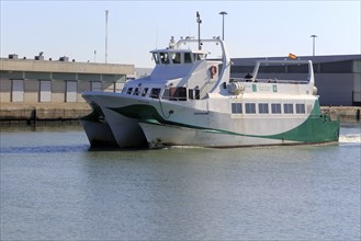 Passenger ferry boat Catamaran Bahia service arriving at Puerto de Santa de Maria, Cadiz province,