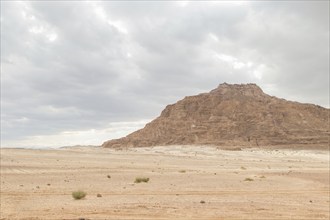 Desert, red mountains, rocks and cloudy sky. Egypt, color canyon, the Sinai Peninsula, Dahab