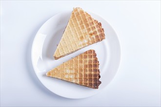 Waffle sandwiches with boiled condensed milk in plate isolated on white background. closeup. top