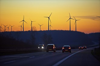 Wind turbines at sunrise with cars on the A 44 motorway, Büren, Paderborn plateau, North