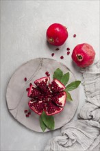 Fresh, cut pomegranate fruit, on a gray background, food concept, top view, no people