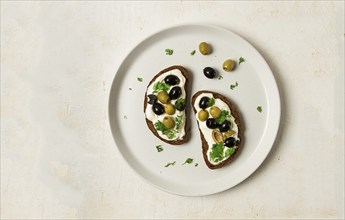 Breakfast, sandwiches, with cream cheese, olives, top view